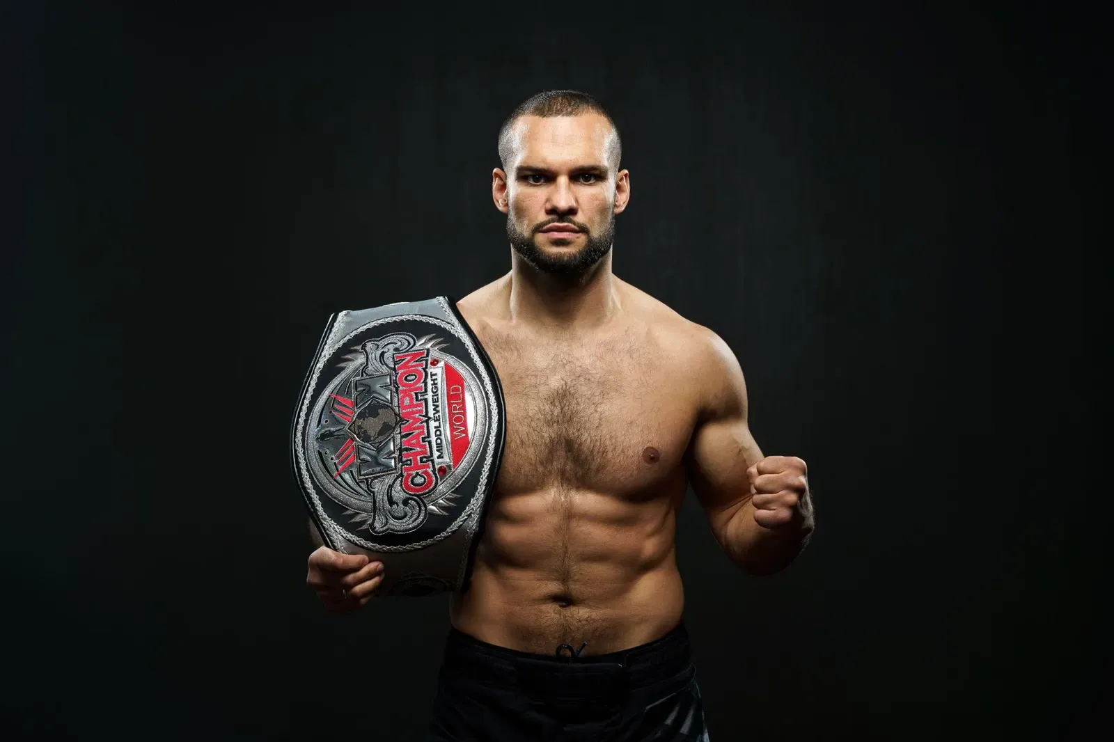 Max Vorovski, founder and head coach, with his championship belt